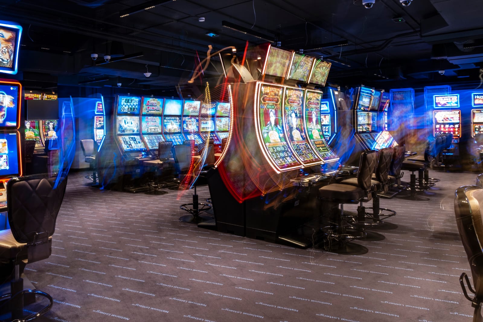 Gaming venue interior with rows of Historical Horse Racing terminals